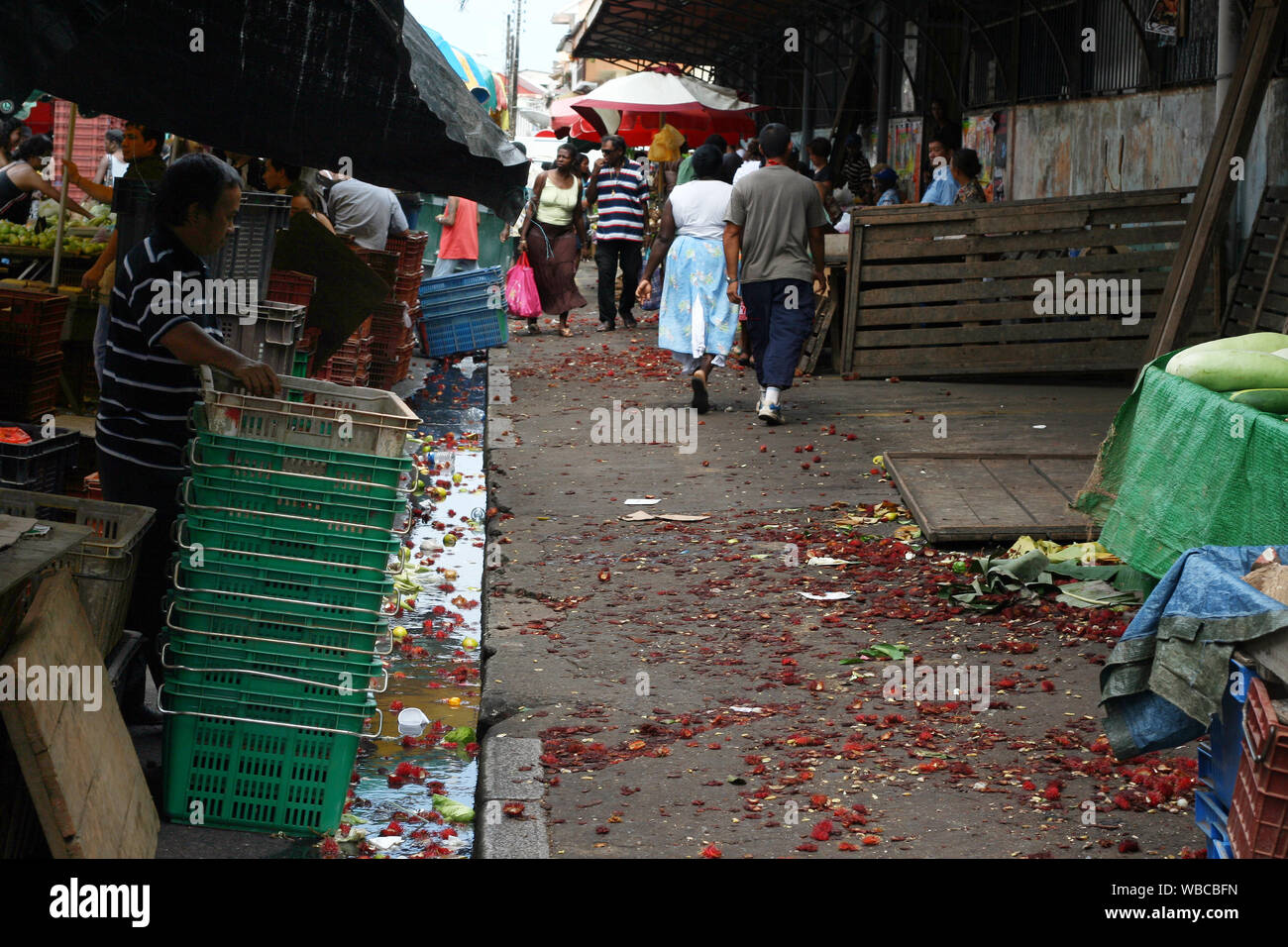 Cayenne, French Guiana - 3.06.2010 - Rambutan season in weekend market, ground covered with rambutan peels Stock Photo