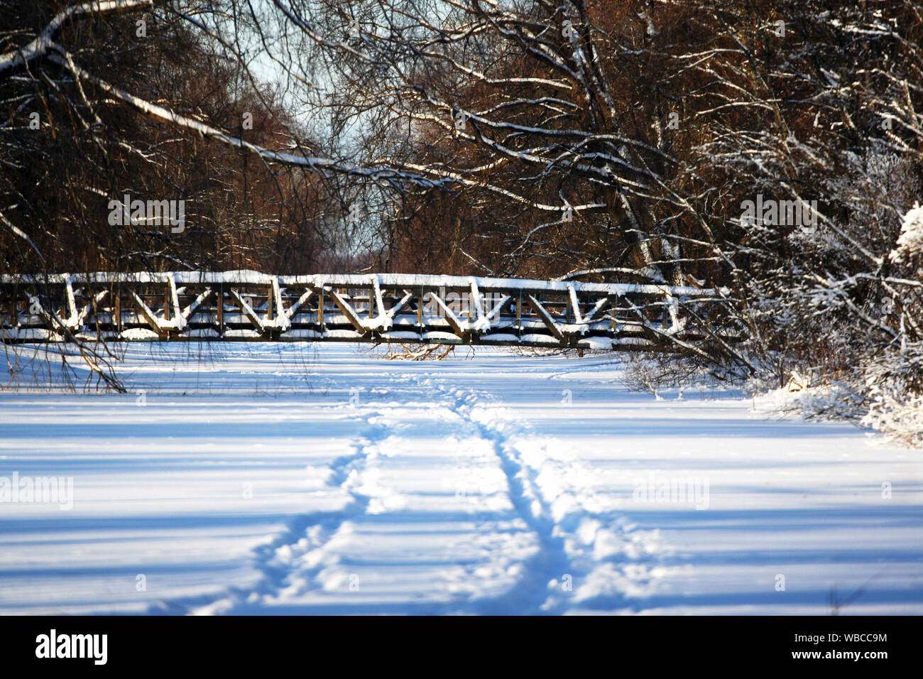 Beautiful view of winter landscape with bridge over frozen river Stock Photo