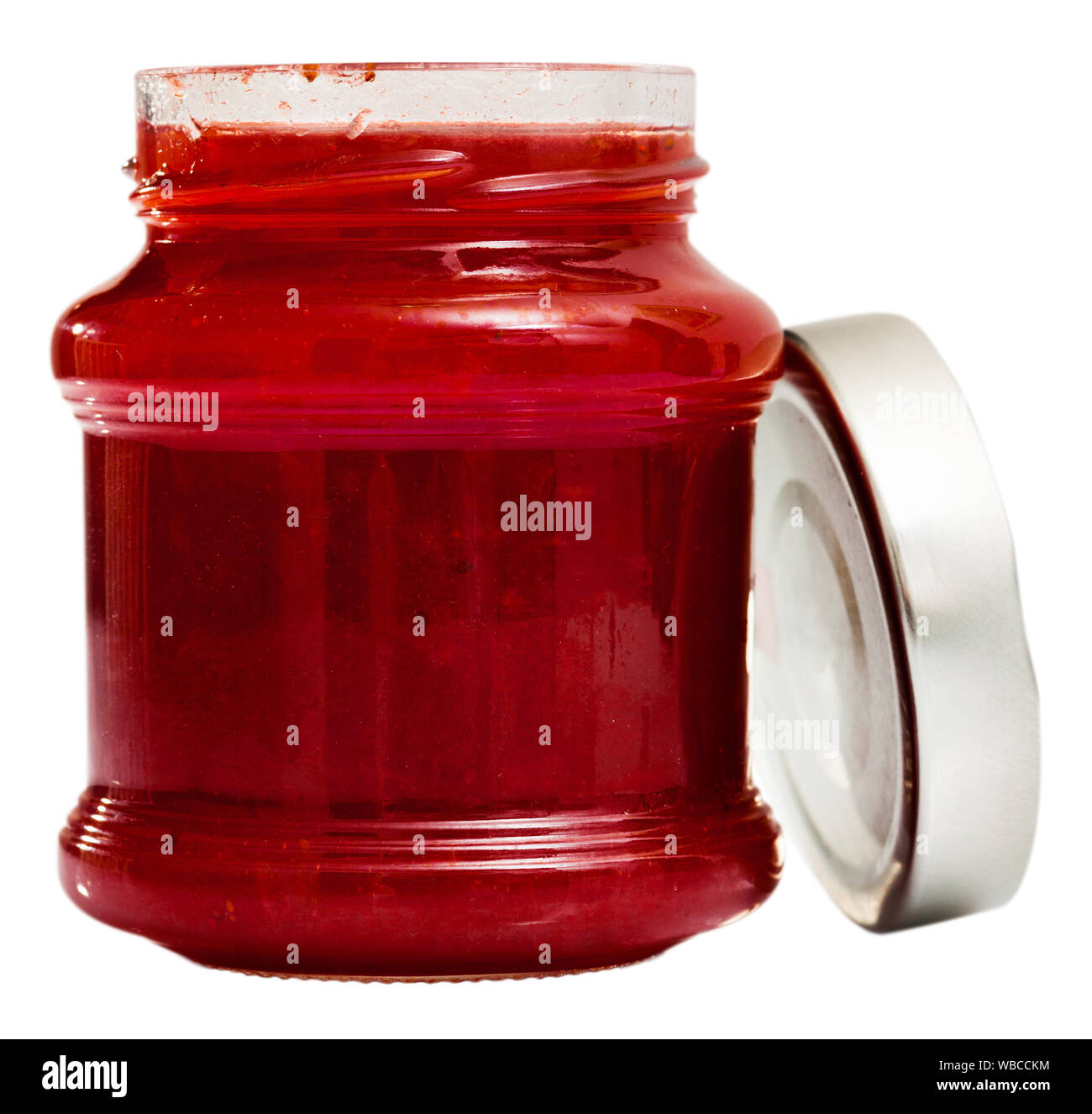 Strawberry jam in a glass jar. Isolated over white background Stock