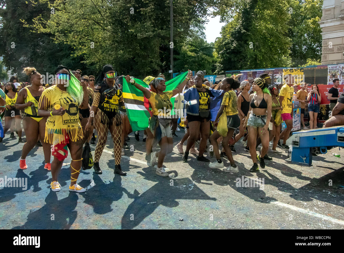 Masqueraders moving along a road. The main events of Notting Hill Carnival 2019 got underway on Sunday, with over a million revellers hitting the streets of West London, amongst floats, masqueraders, steel bands, and sound systems. Stock Photo