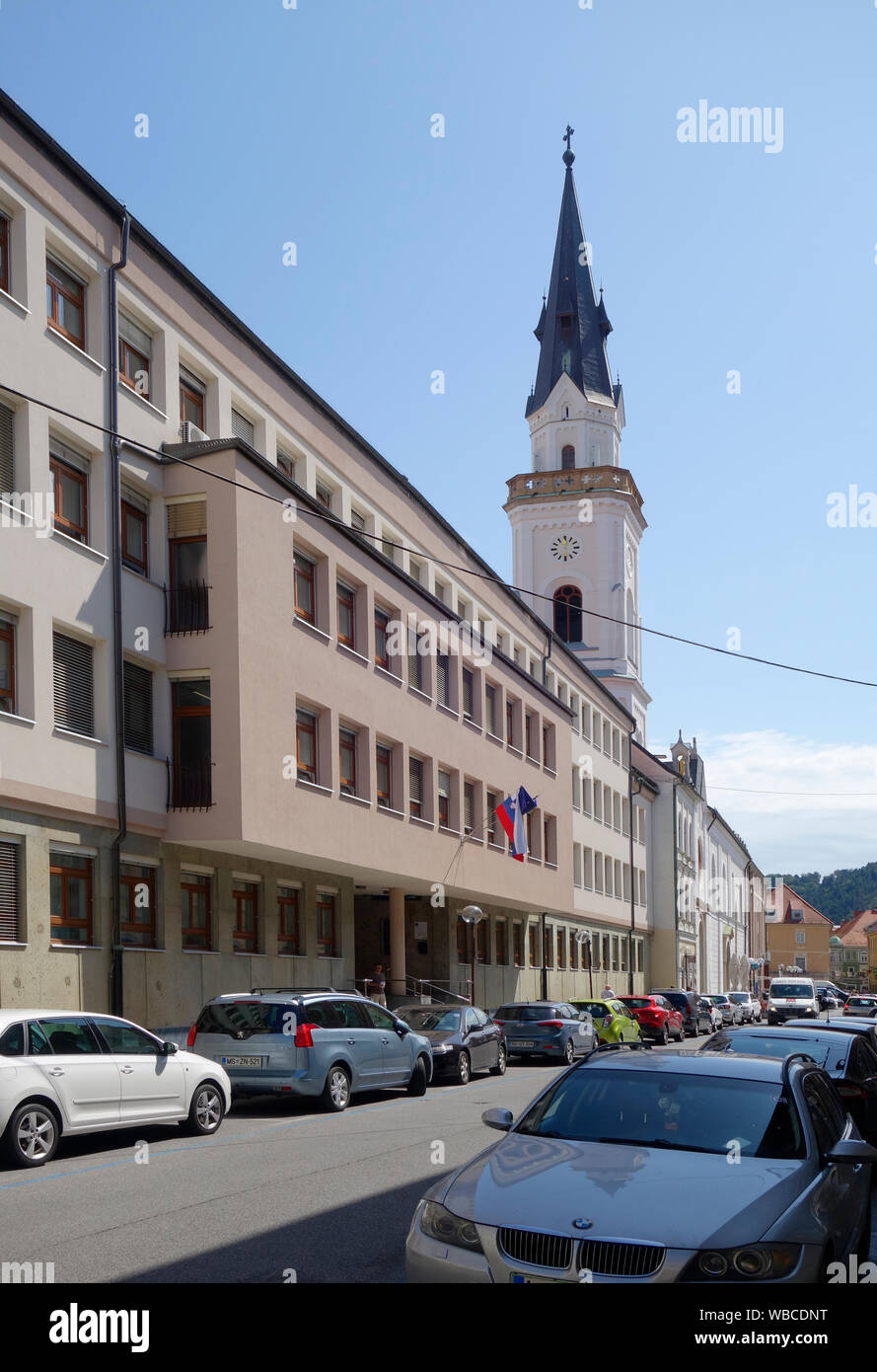 Slovenija, Celje. Presernova street with Church of the Assumption of Mary (Cerkev Marijinega vnebovzetja) and District Court. Stock Photo