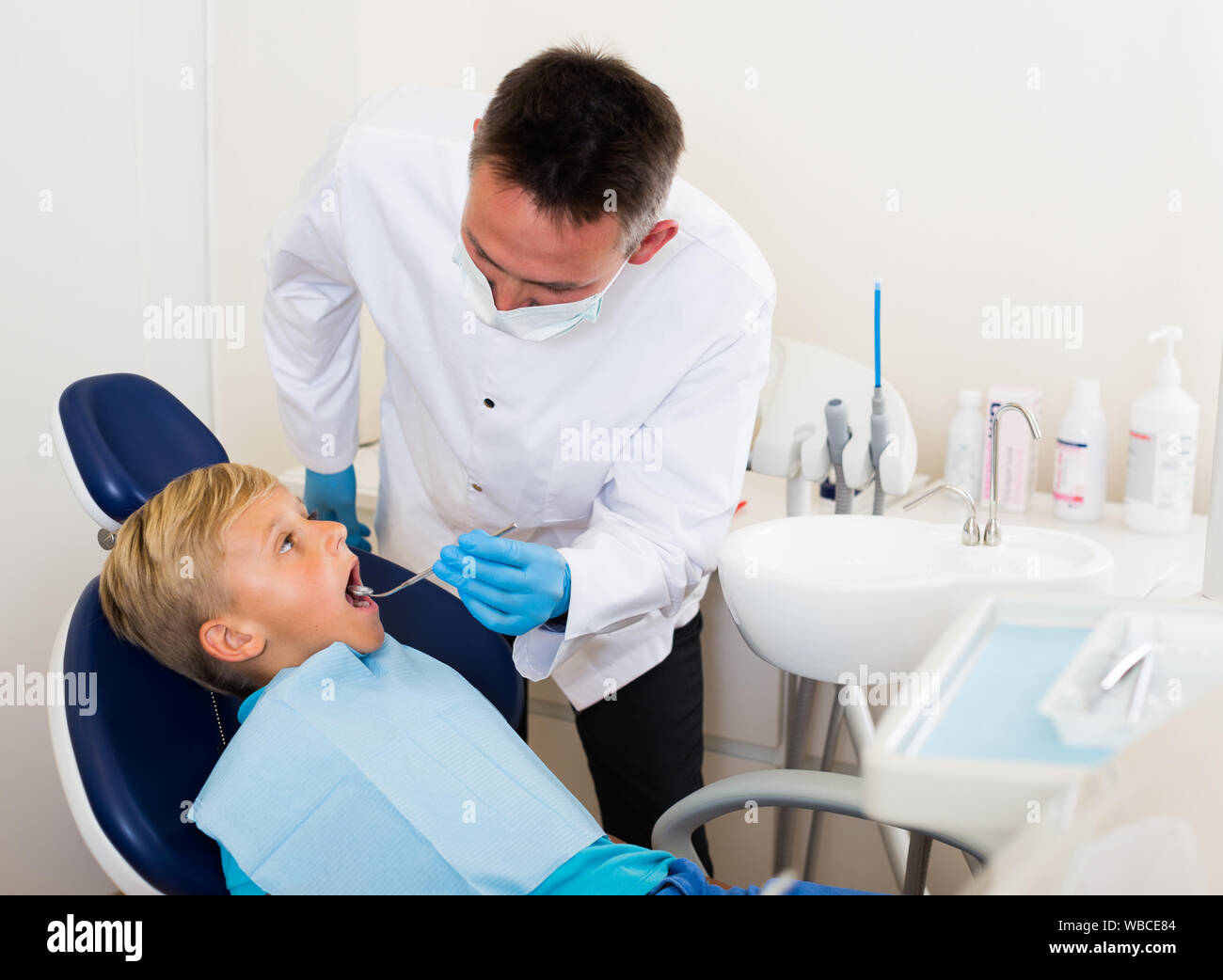 Orthodontist in uniform is examinating patient in hospital Stock Photo Alamy