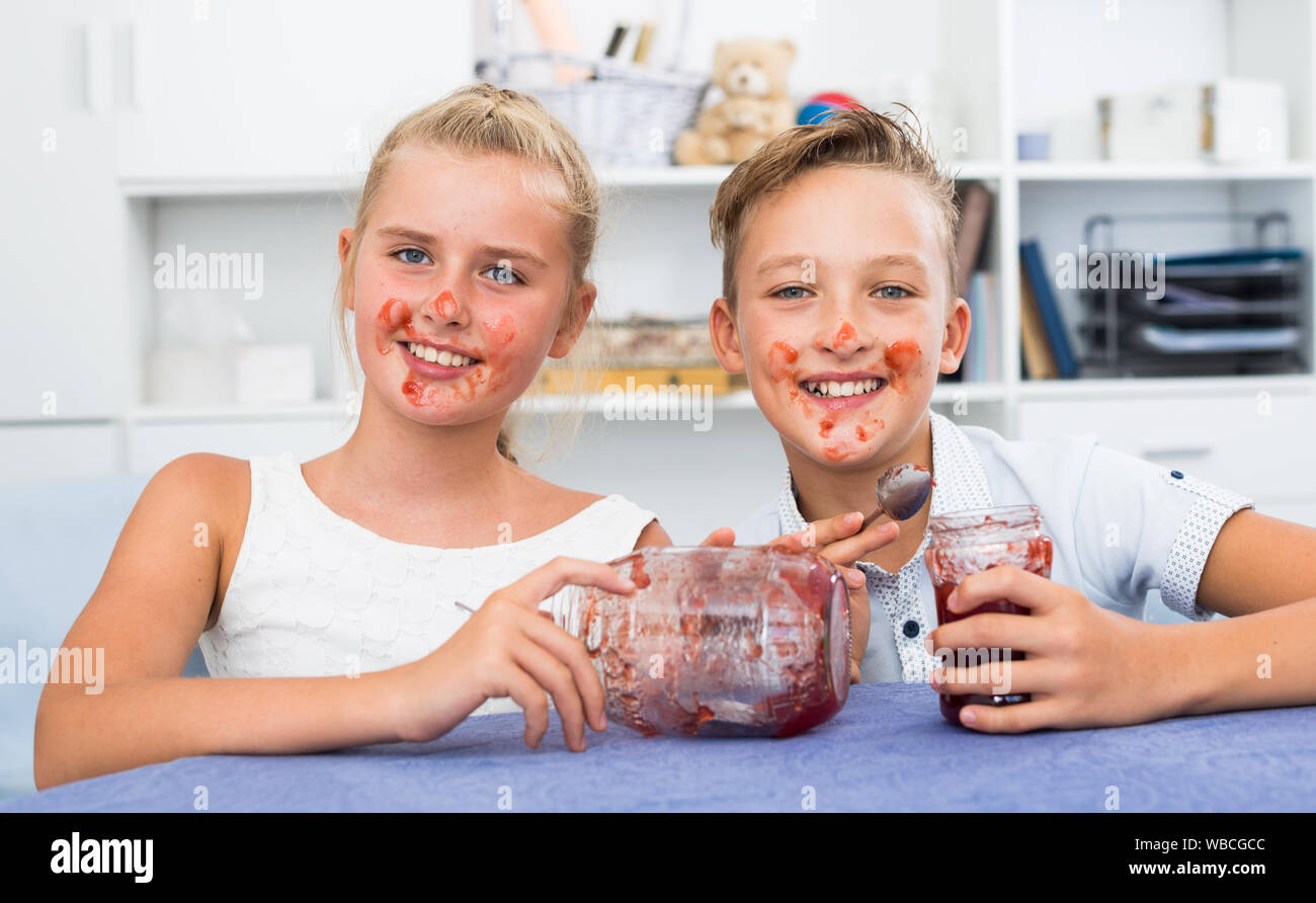 Girl and boy are eating jam at lunch time Stock Photo Alamy