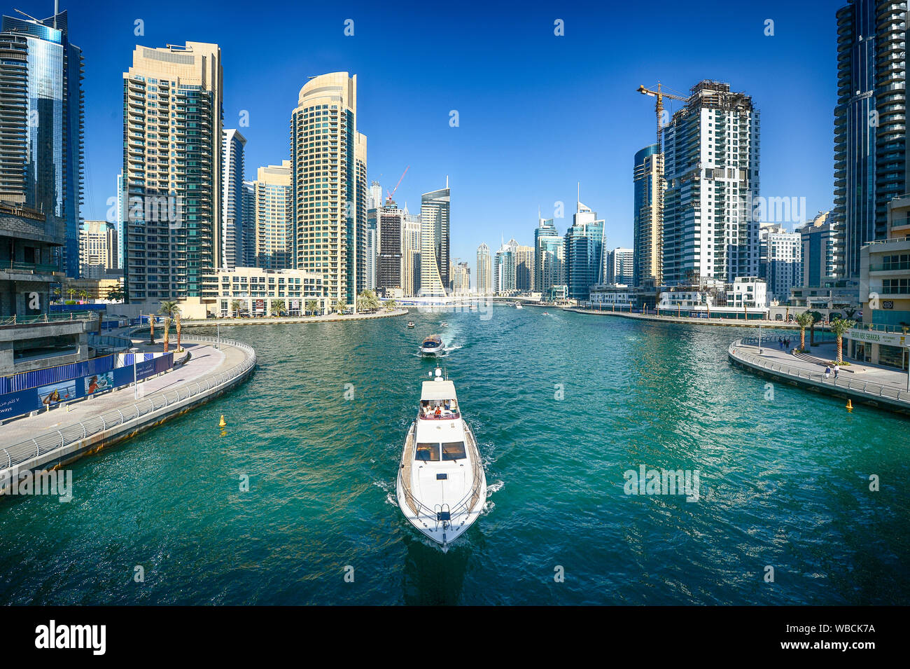 Boat through the canals of Dubai Marina in the city of Dubai Stock Photo