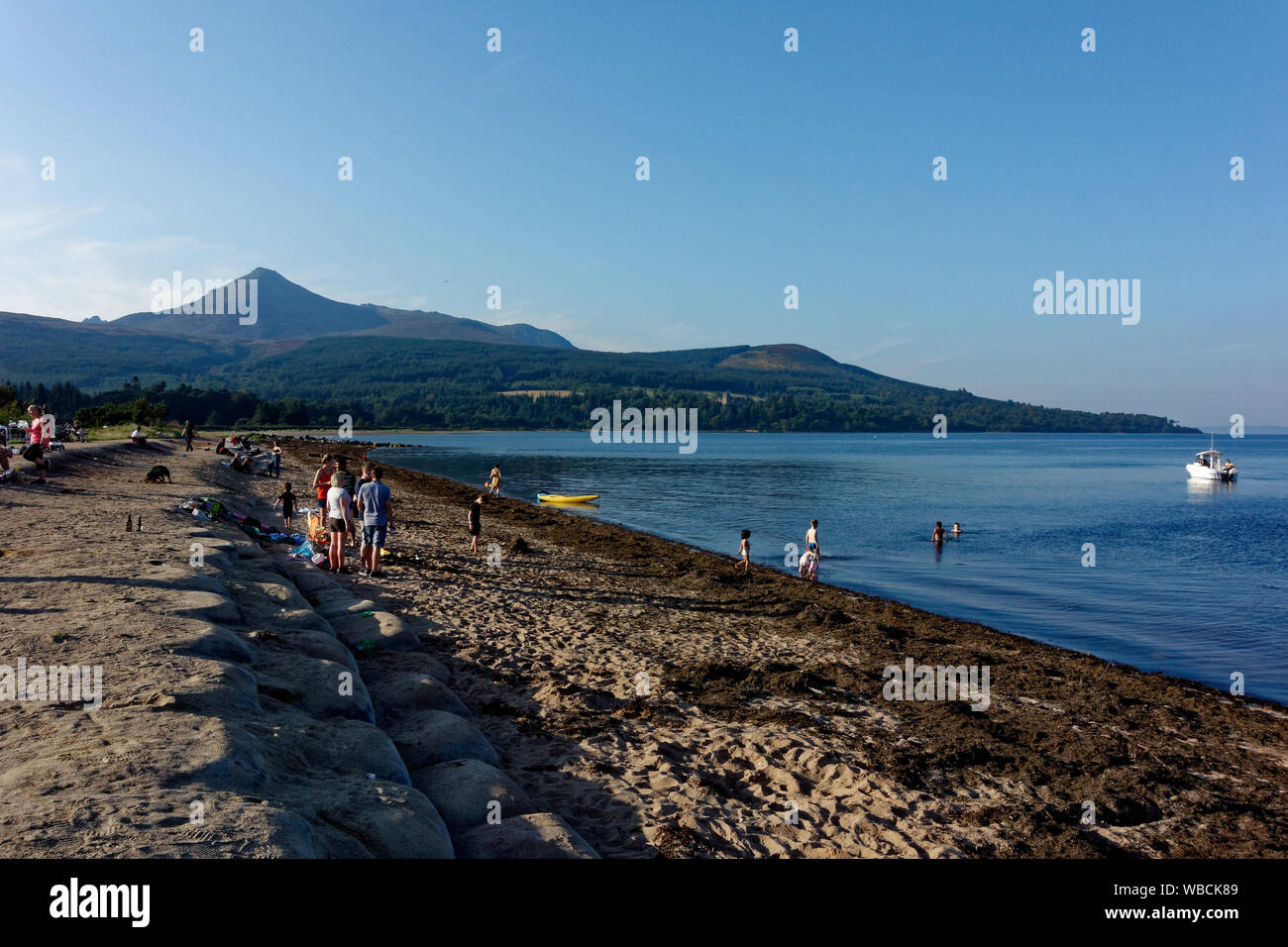 People enjoying a summers day at the beaching Brodick, Isle of Arran, Scotland, United Kingdom Stock Photo