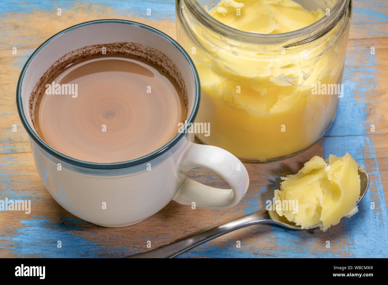 cup of fresh fatty coffee with ghee (clarified butter), MCT oil and cinnamon - ketogenic diet concept Stock Photo