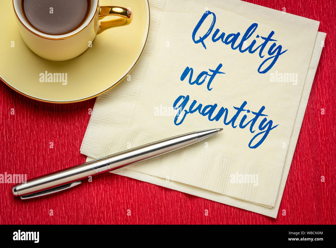 quality not quantity - inspirational handwriting on a npkin with a cup of coffee Stock Photo