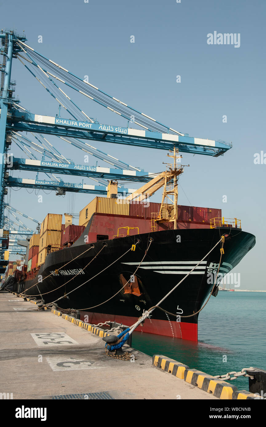 Shipping containers being loaded onto a ship at Khalifa Port, Abu Dhabi ...