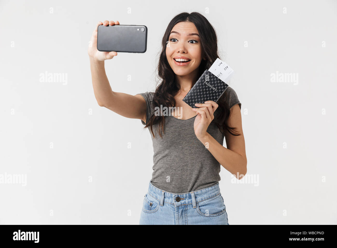 Image of a beautiful excited happy young woman posing isolated over ...