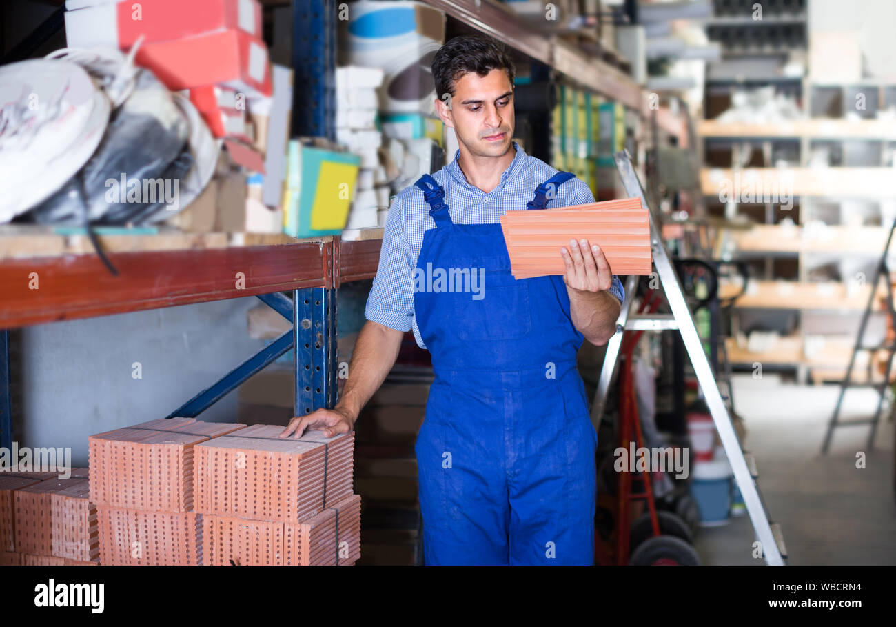 Builder is choosing tiles in the building store. Stock Photo