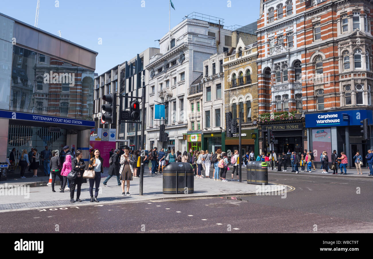 London, UK - August  2019: Busy crossroads with pedestrians tourists and cars in front of Tottenham Court Road Station, Central London, UK Stock Photo