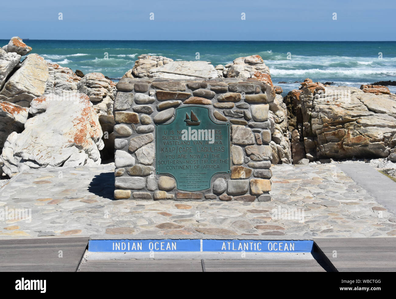 plaque at southernmost point of Africa against Atlantic Ocean and Indian Ocean at Cape Agulhas on sunny day Stock Photo