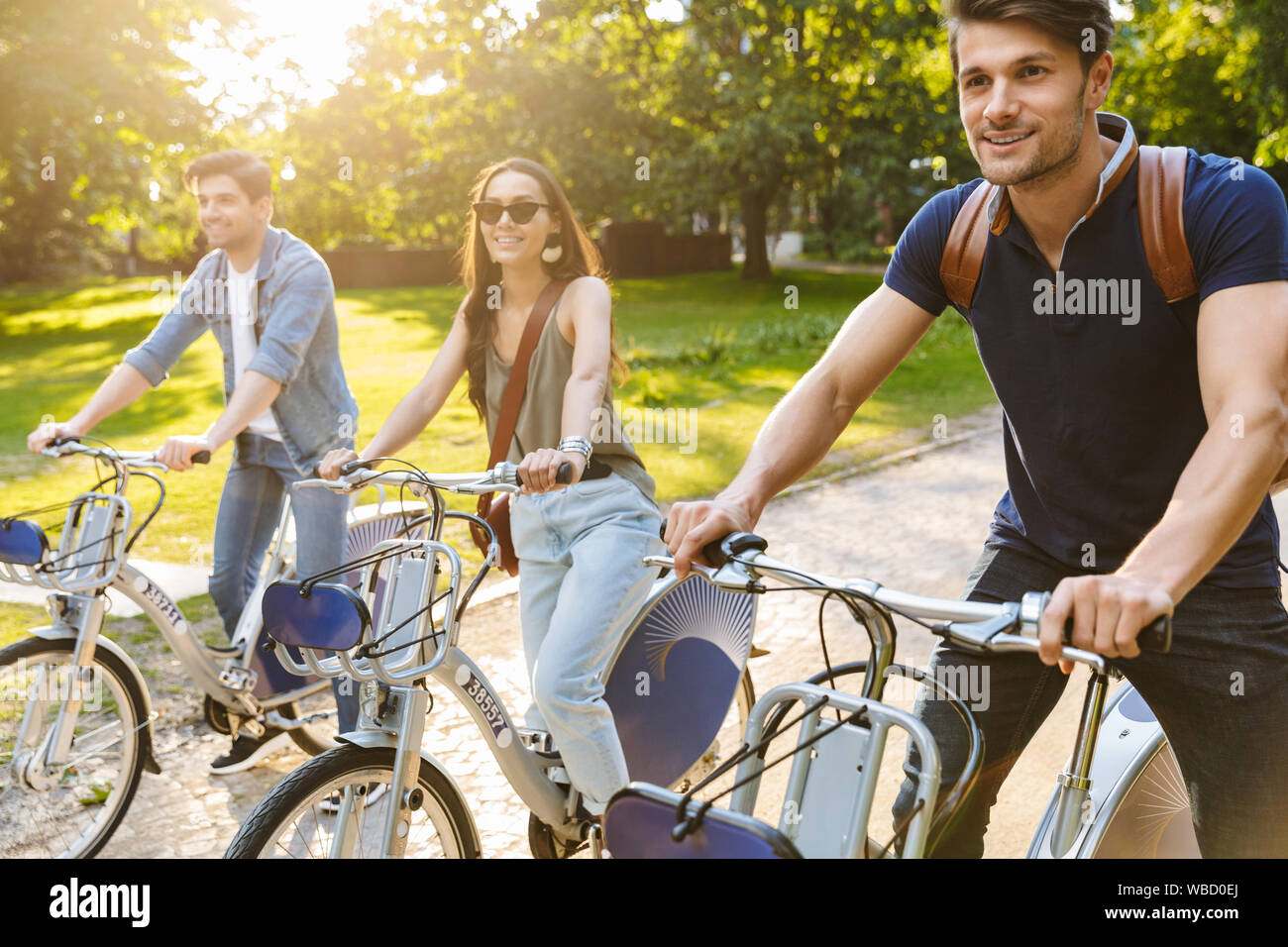 Friends cycling in park hi-res stock photography and images - Alamy