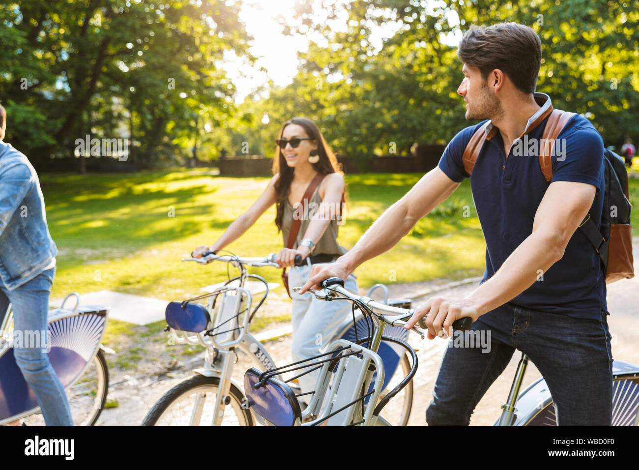Group of happy cheerful friends riding bicycles at the park Stock Photo ...