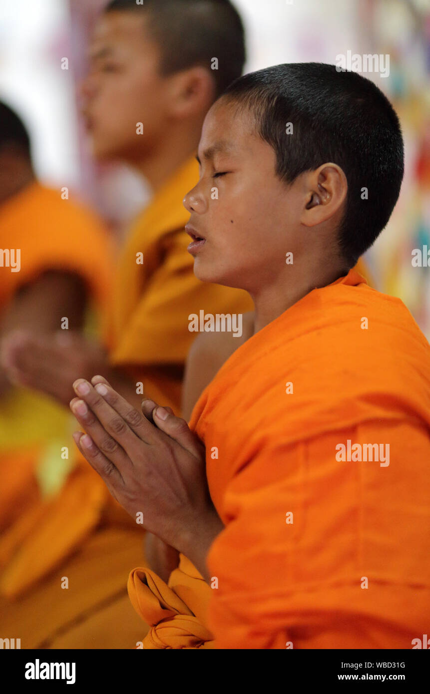 Buddhist novice in a monastic school in Luang Prabang, Laos. Buddhism is an important part of daily life in Luang Prabang Stock Photo