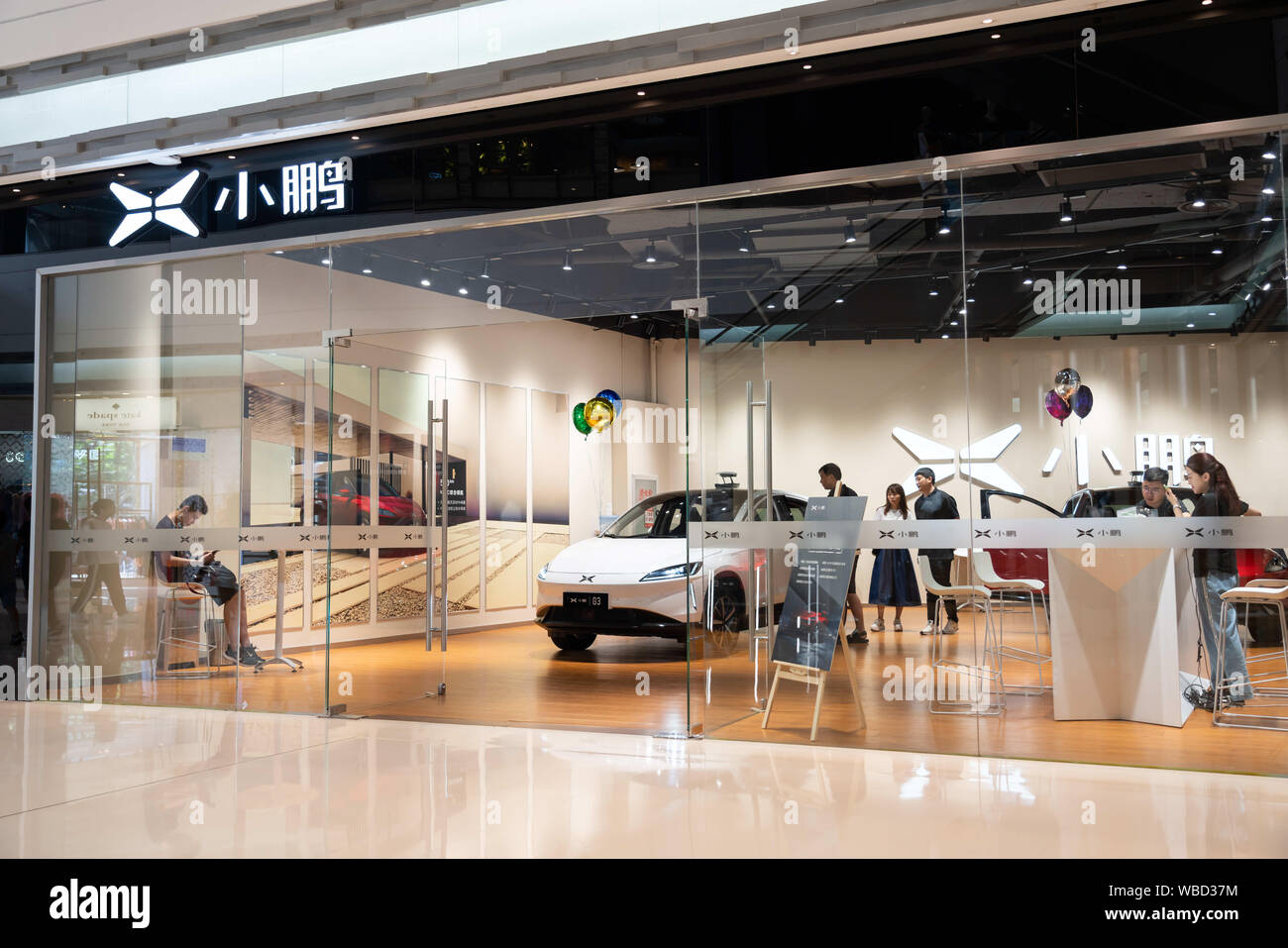 Shanghai, China. 25th Aug, 2019. Customers experiencing a new car at the Chinese automobile manufacturer XPeng or Xiaopeng Motors store in Shanghai. Credit: Alex Tai/SOPA Images/ZUMA Wire/Alamy Live News Stock Photo