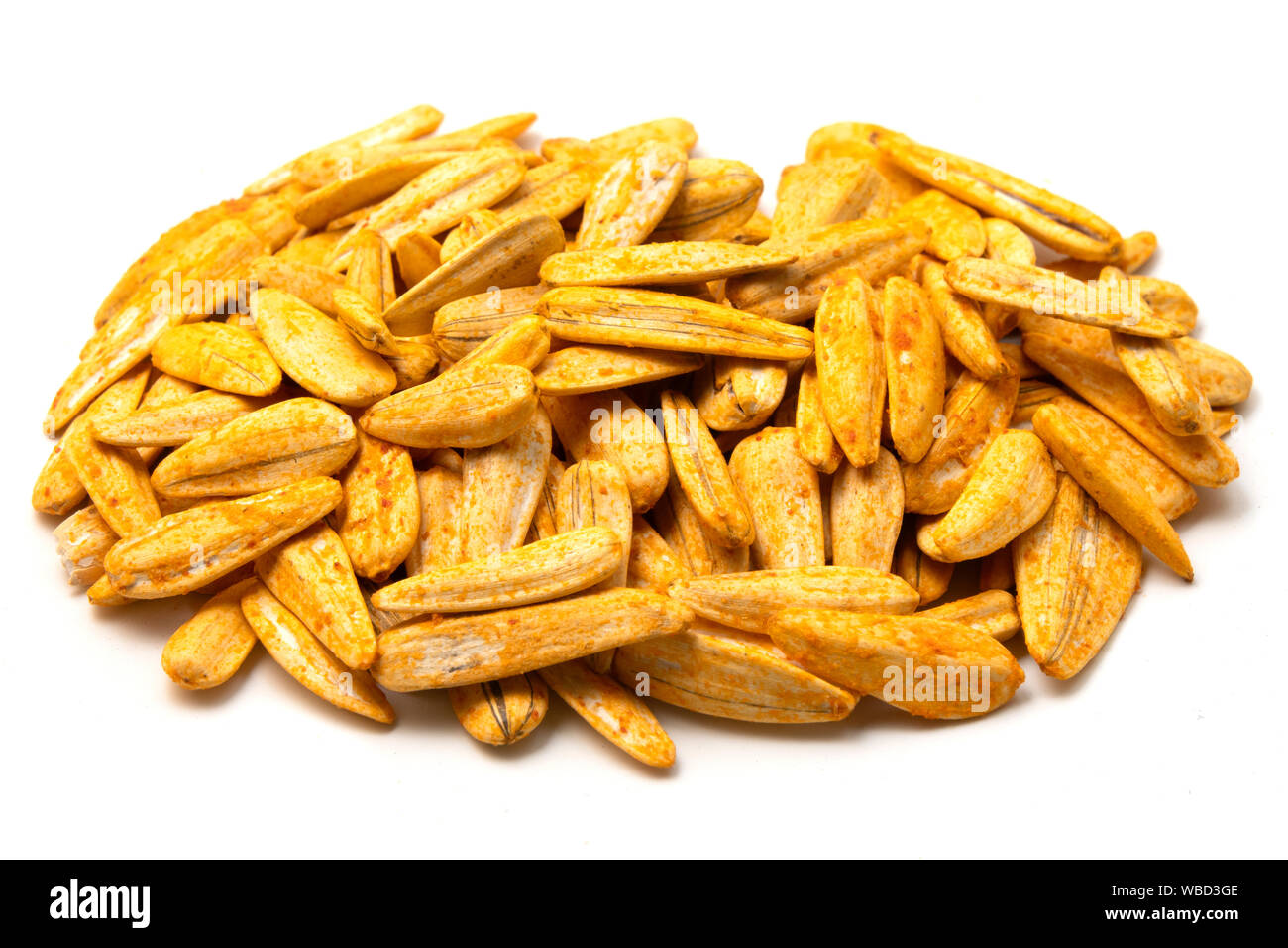 Roasted white sunflower seeds with hot sauce on a white background