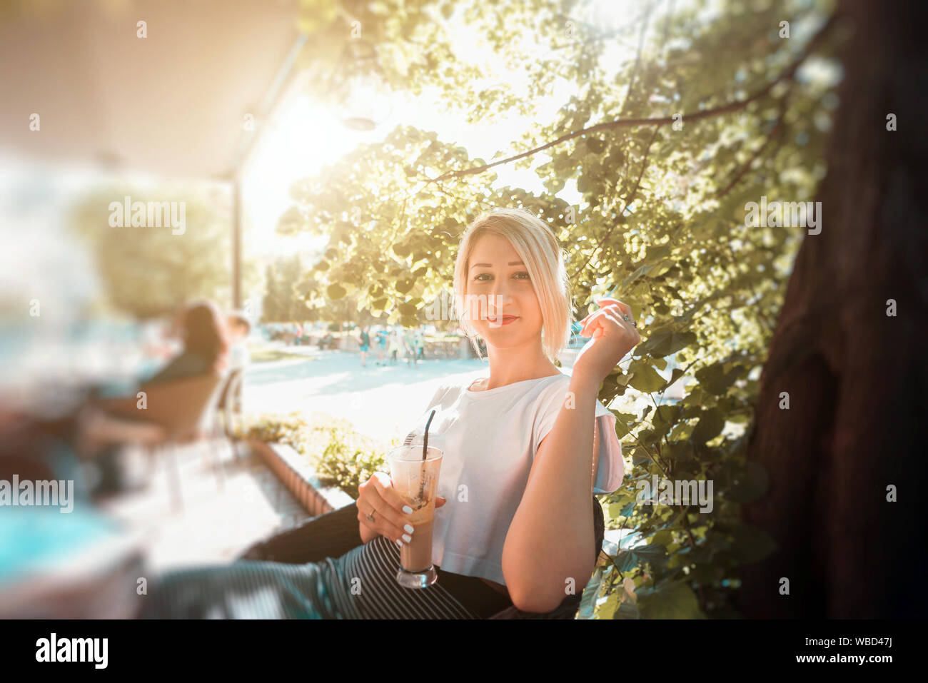 Young woman sitting in cafe Stock Photo