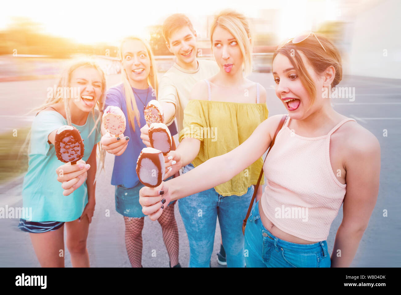 Friends making funny faces and eating ice cream Stock Photo