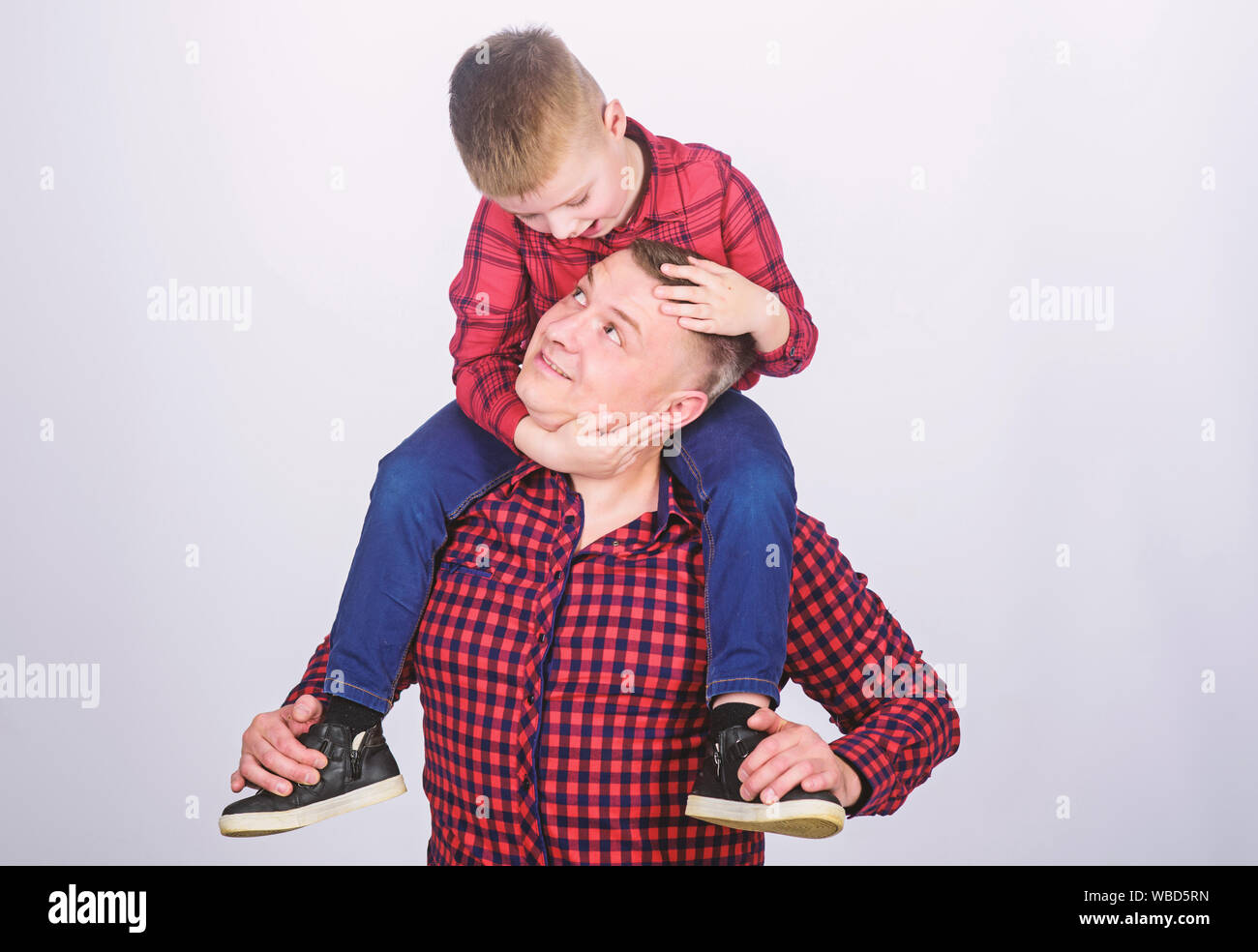 Spending carefree time. father and son in red checkered shirt. little boy with dad man. fathers day. happy family. childhood. parenting. Family is the most important thing. My funny friend Stock Photo - Spending carefree time. father and son in red checkered shirt. little boy with dad man. fathers day. happy family. childhood. parenting. Family is the most important thing. My funny friend Stock Photo -
