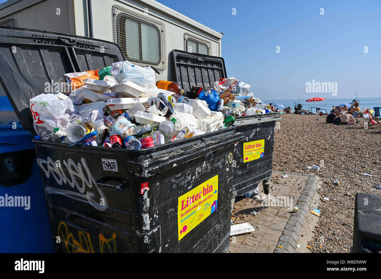 Brighton, UK. 26 August 2019.  Rubbish and litter by the communal bins as Brighton beach is packed on August Bank Holiday Monday in hot sunshine as temperatures soar into the high twenties again . Yesterday saw record temperatures being set for an August bank holiday in West London . Credit : Simon Dack / Alamy Live News Stock Photo