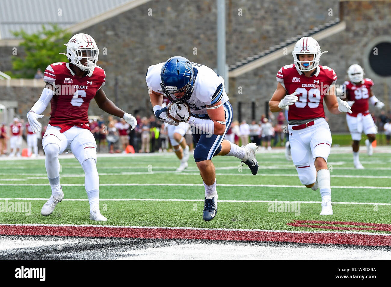 August 24, 2019: Villanova Wildcats wide receiver Andrew Perez (80) leaps into the end zone for a touchdown between Colgate Raiders defensive back Marques Bruce (6) and linebacker Hayden Howren (39) during the first half of an NCAA football game on Saturday, Aug., 24, 2019 at Andy Kerr Stadium in Hamilton, New York. Rich Barnes/CSM Stock Photo