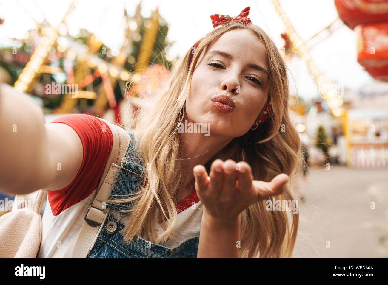 Image Of Pretty Blonde Woman Wearing Girlish Clothes Blowing Air