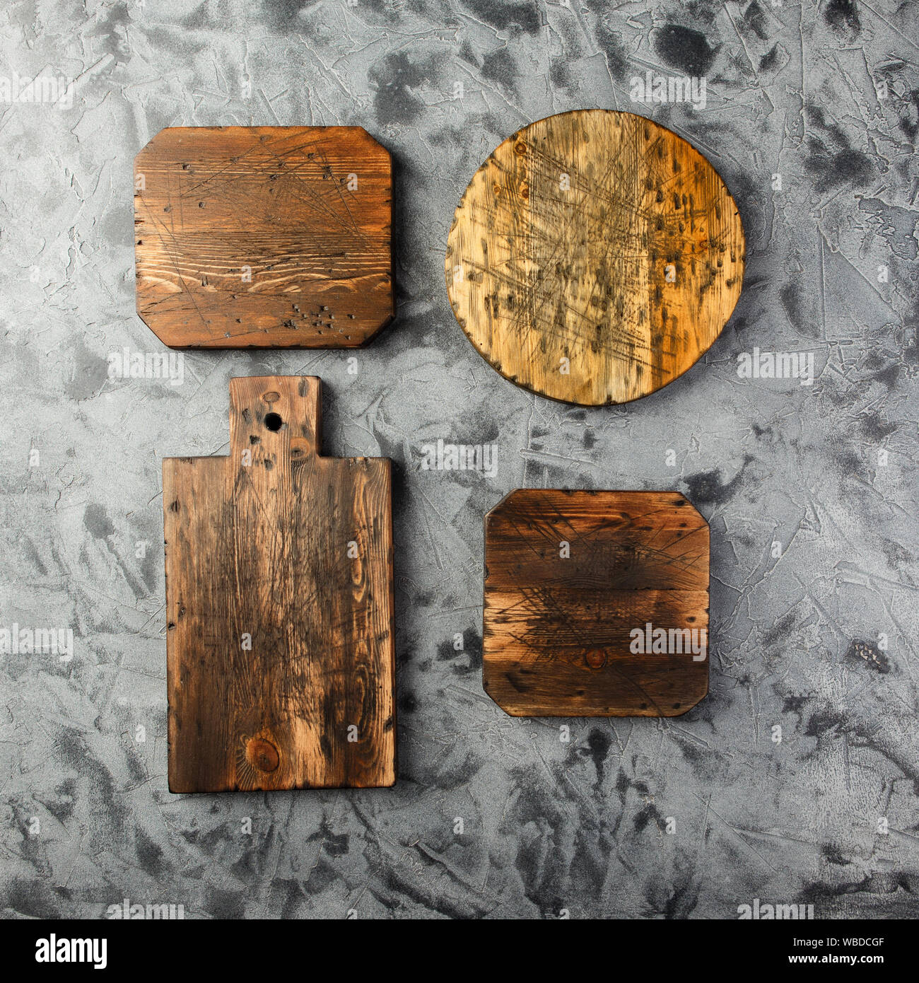Set of wooden cutting boards on grey background. Stock Photo