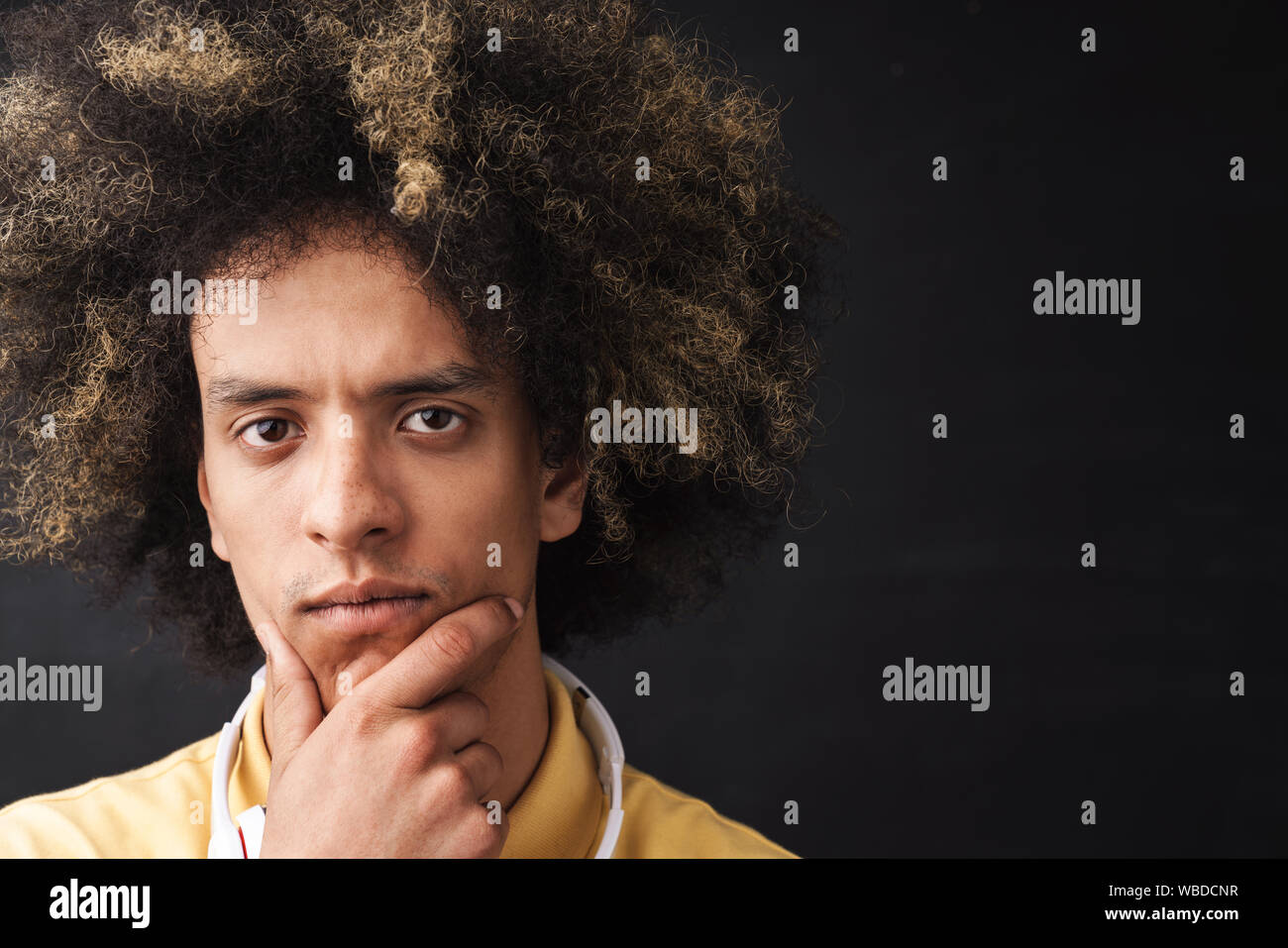 Photo Of A Curly Young Thinking Thoughtful Serious Teenage Guy
