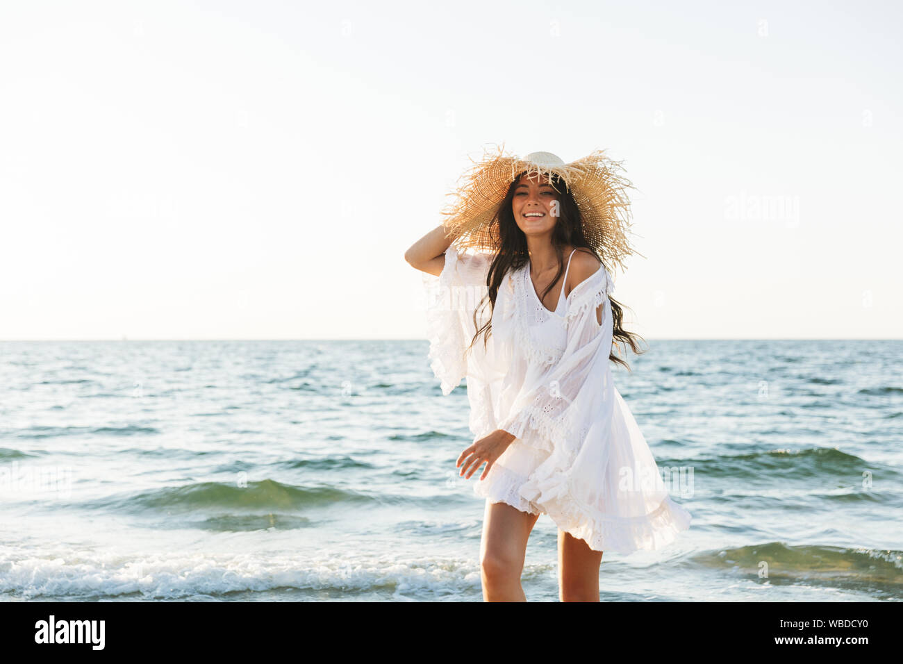 young brunette woman in beach dress 