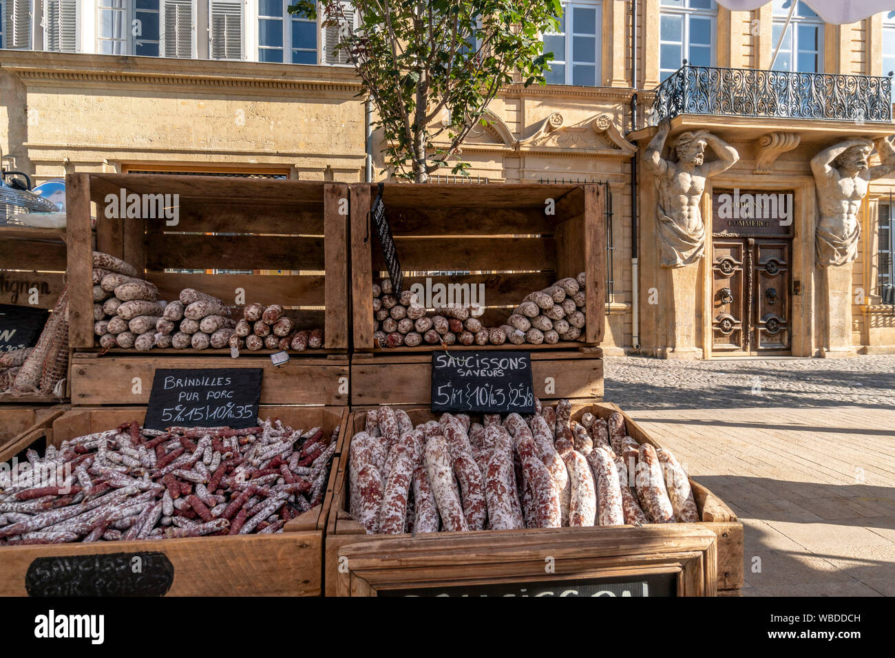 market stall with sausages , background Tribunal de Commerce, Hotel Maurel de Ponteves, hotel particulier, Cours Mirabeau, Aix en Provence, france Stock Photo