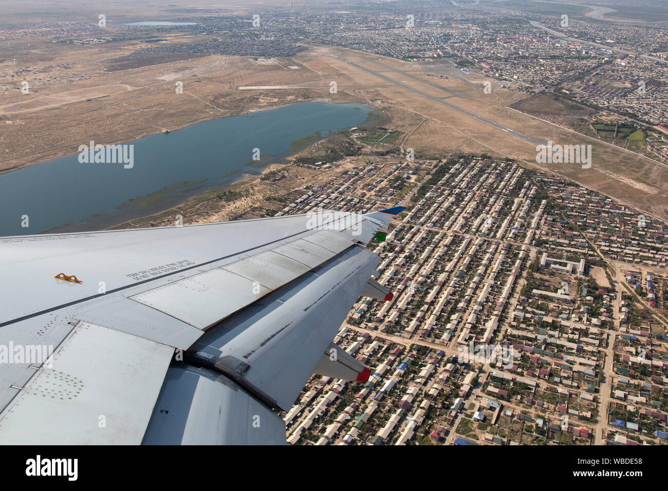 Aerial view looking down on Urgench International Airport in Uzbekistan from an aeroplane. Stock Photo