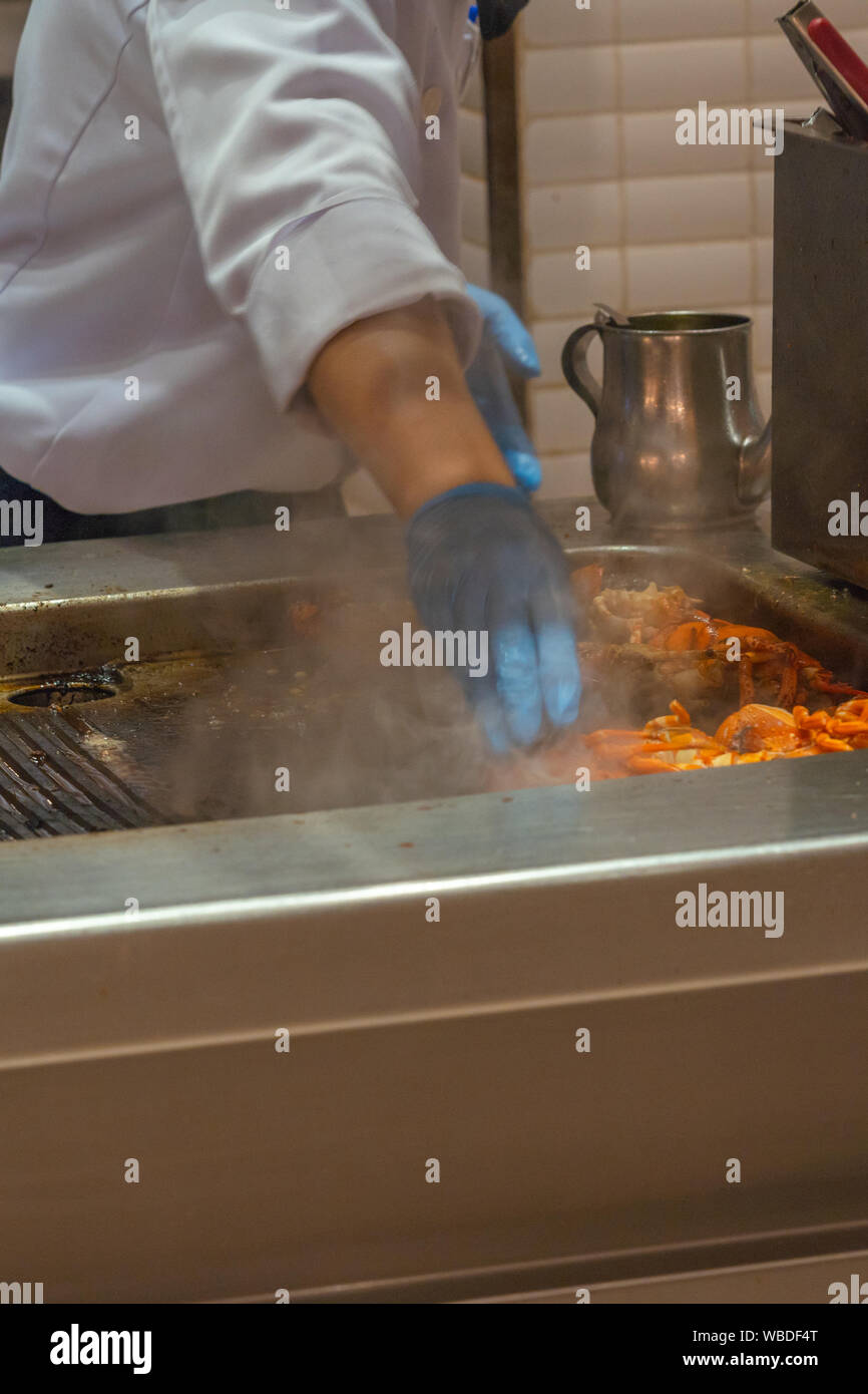 Vertical Photo Of The Chef Grilling Crayfish On Electric Stove