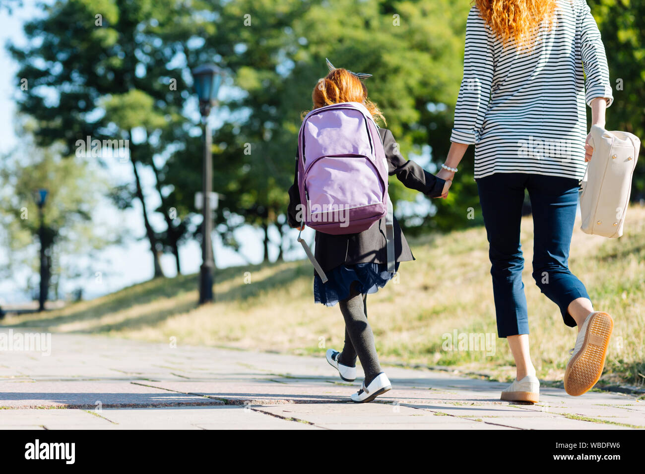 Charming single parent walking with her kid Stock Photo