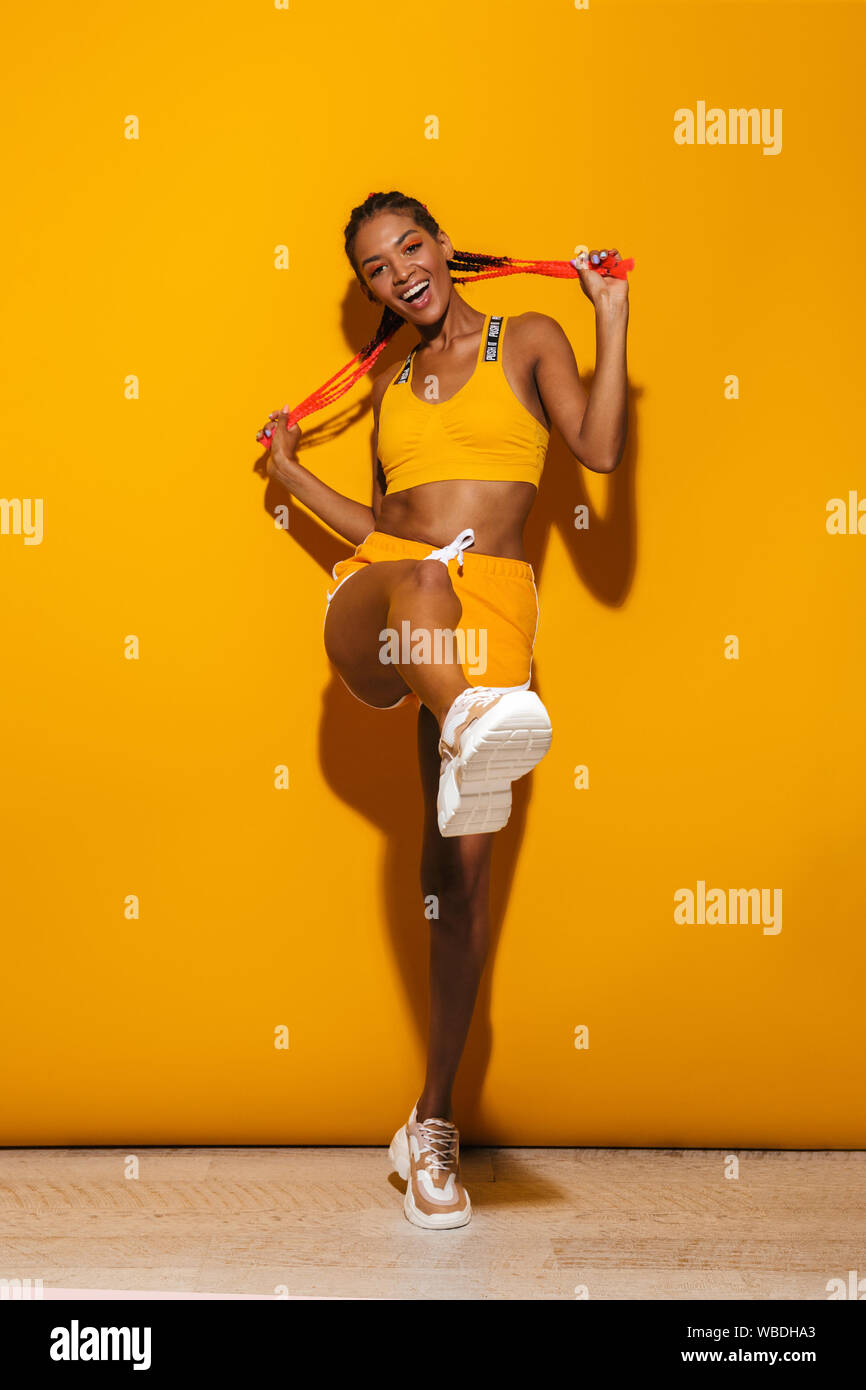 Beautiful woman dancing over yellow hi-res stock photography and images ...