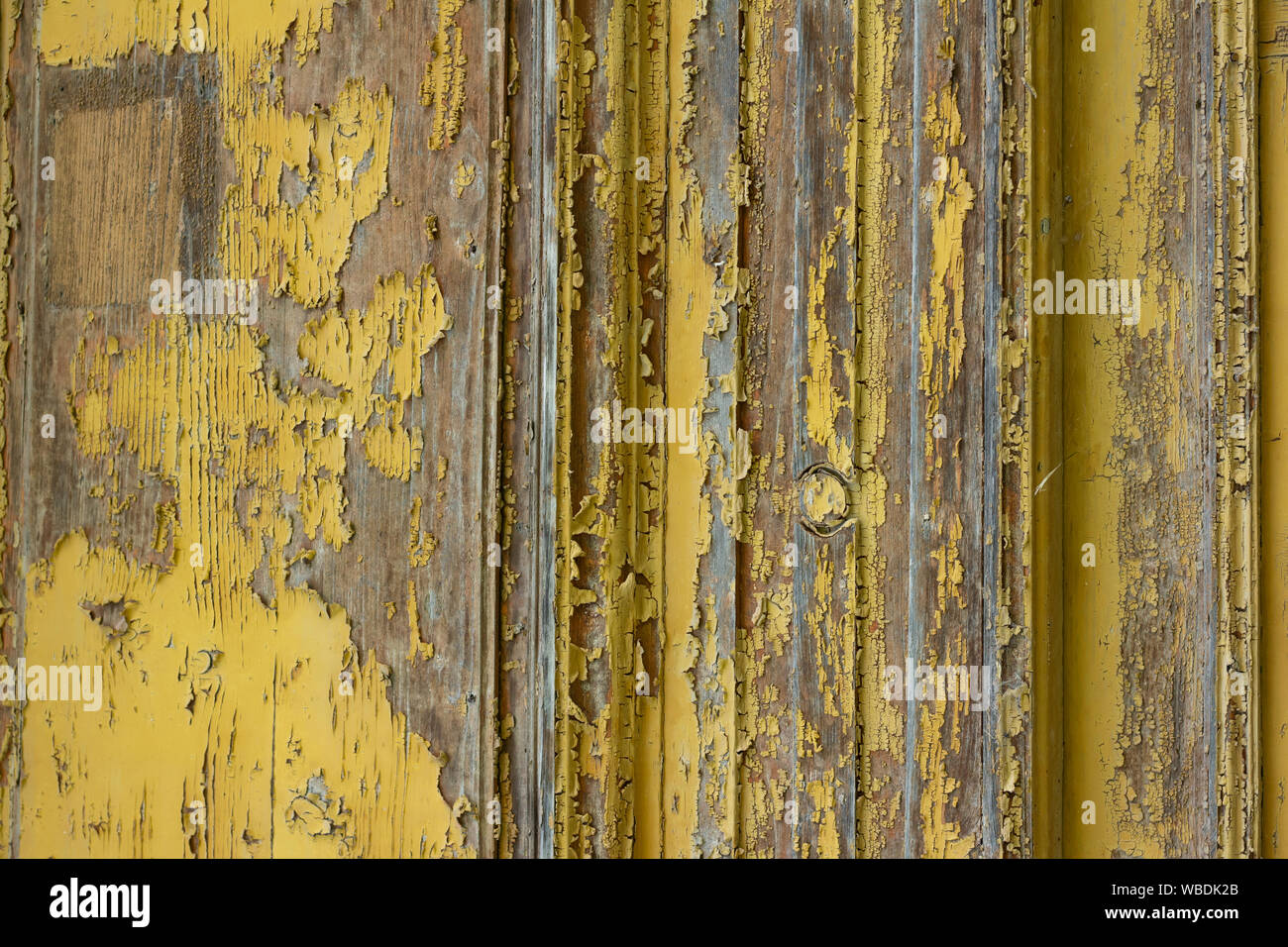 weathered wood background with peeling yellow paint Stock Photo