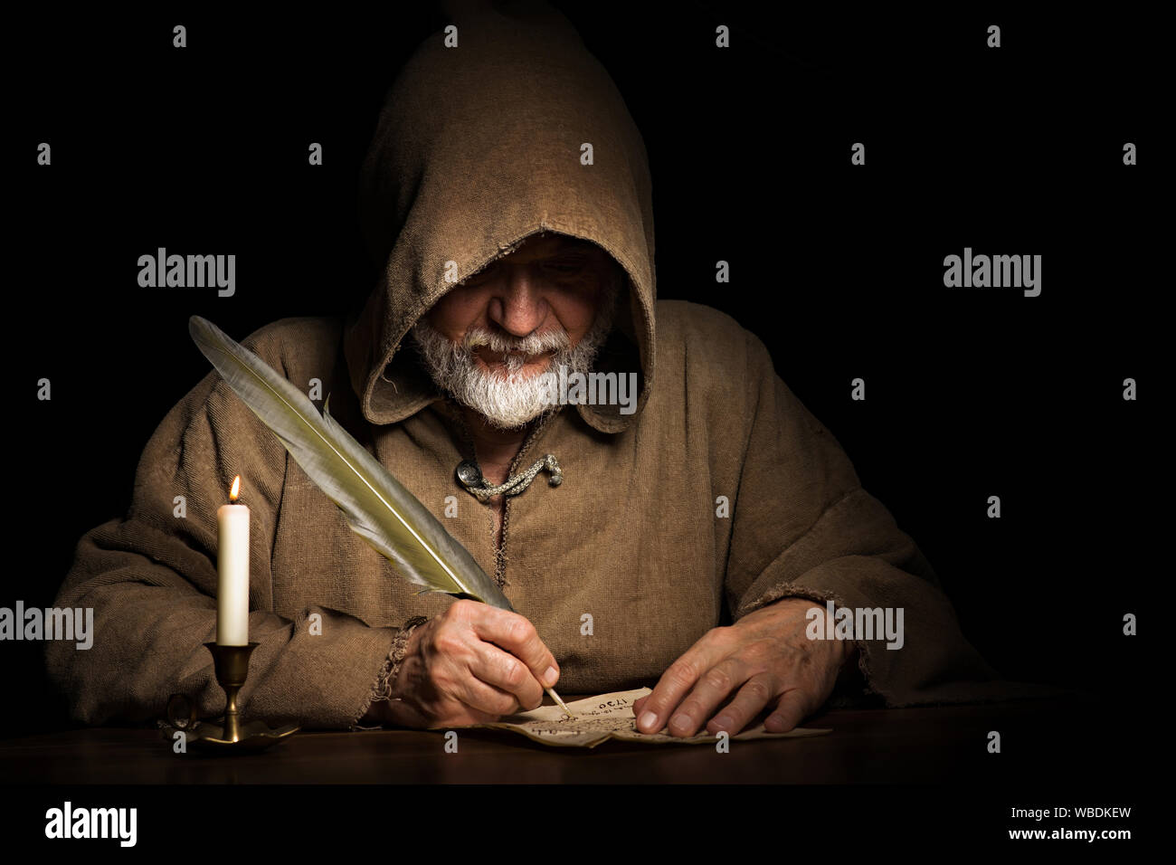 mysterious medieval monk writes letter Stock Photo