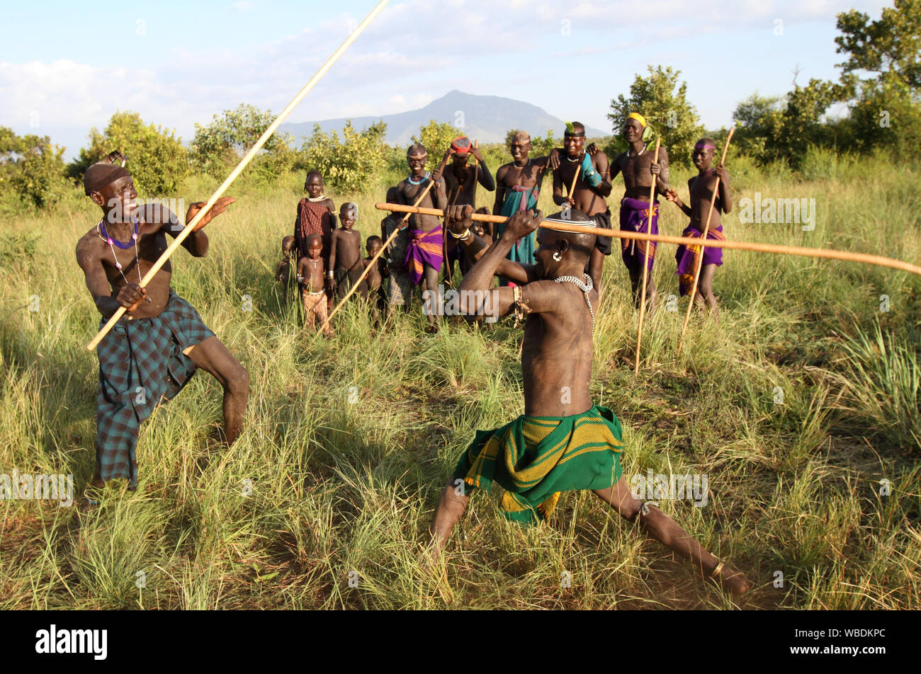 Mursi warriors during a stick fight in Mago National Park, Lower Omo Valley, Ethiopia Stock Photo