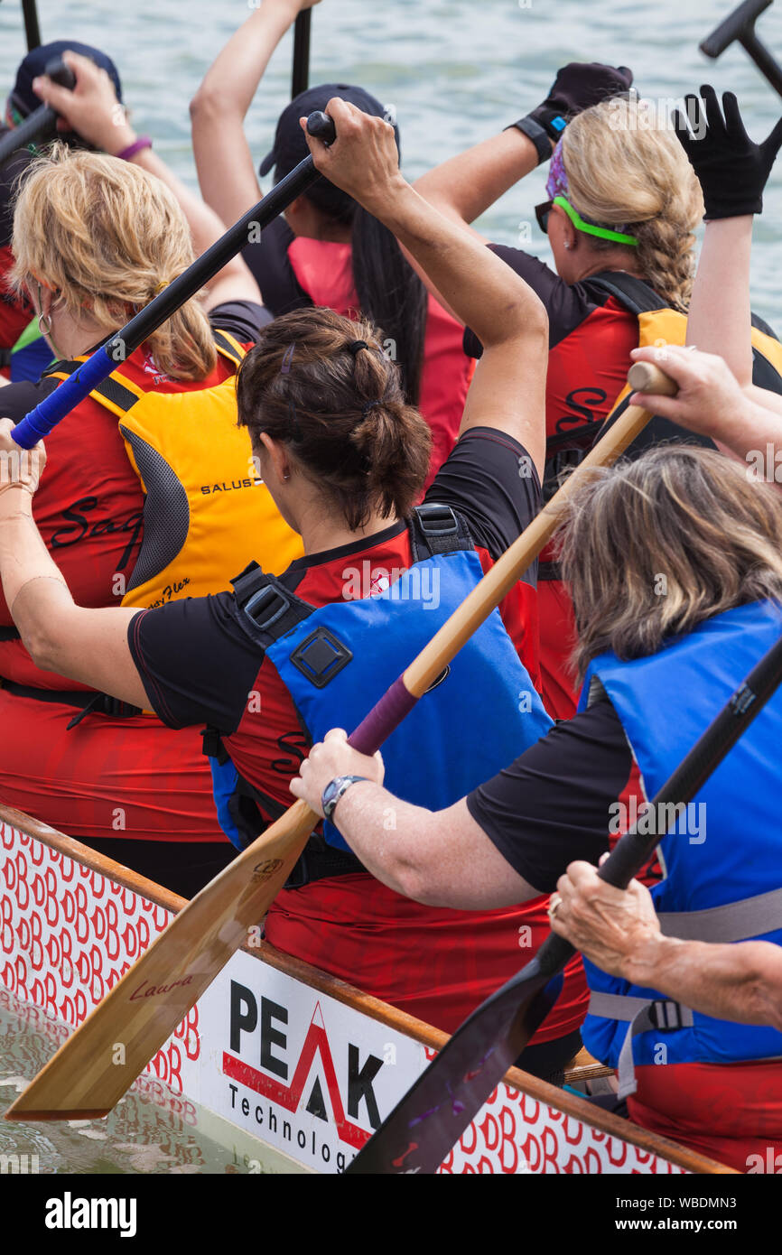Womens team returning to the dock after finishing their heat at the 2019 Steveston Dragon Boat Festival in British Columbia Canada Stock Photo