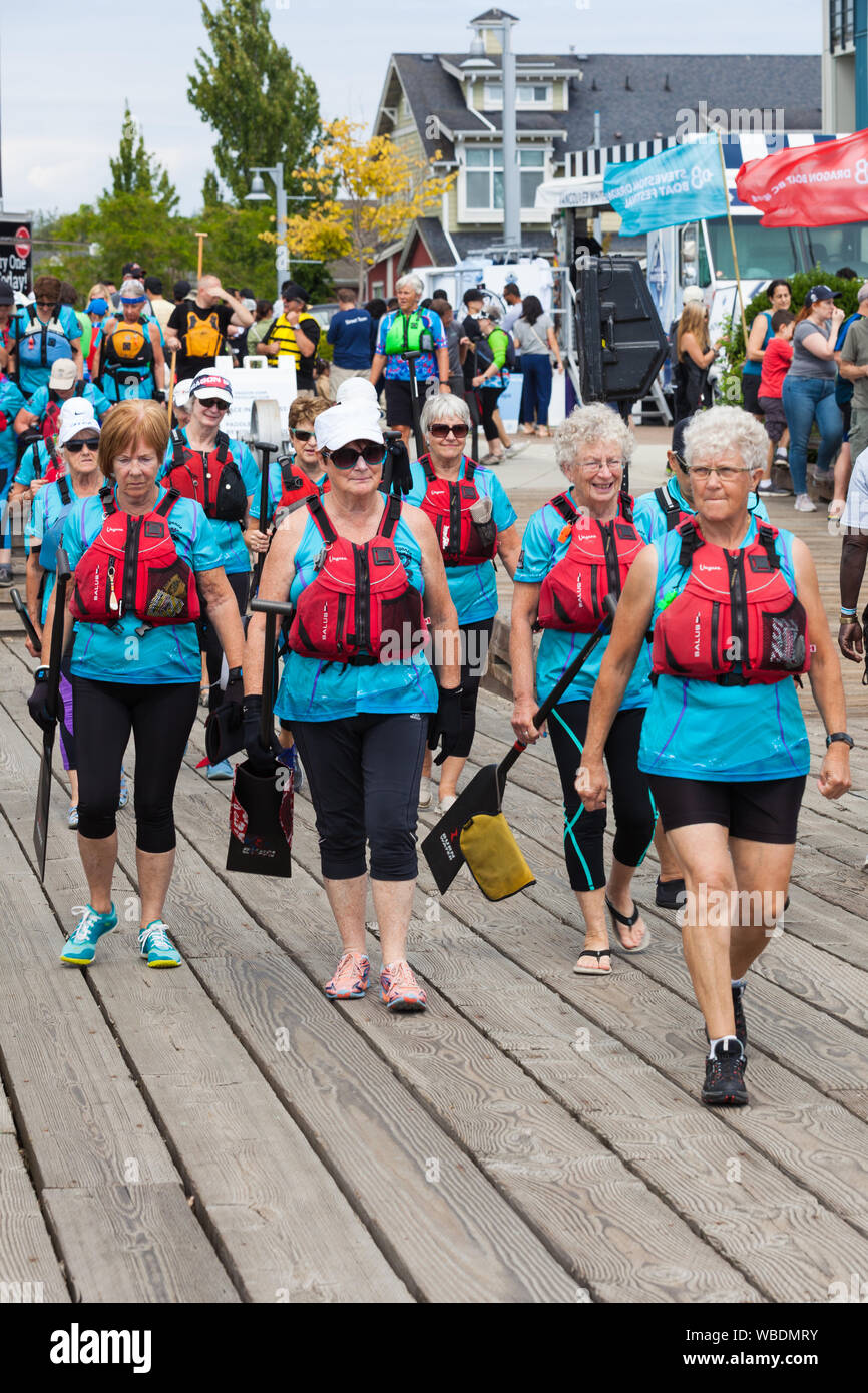 Senior ladies team walking to their boat at the 2019 Steveston Dragon Boat Festival in British Columbia, Canada Stock Photo