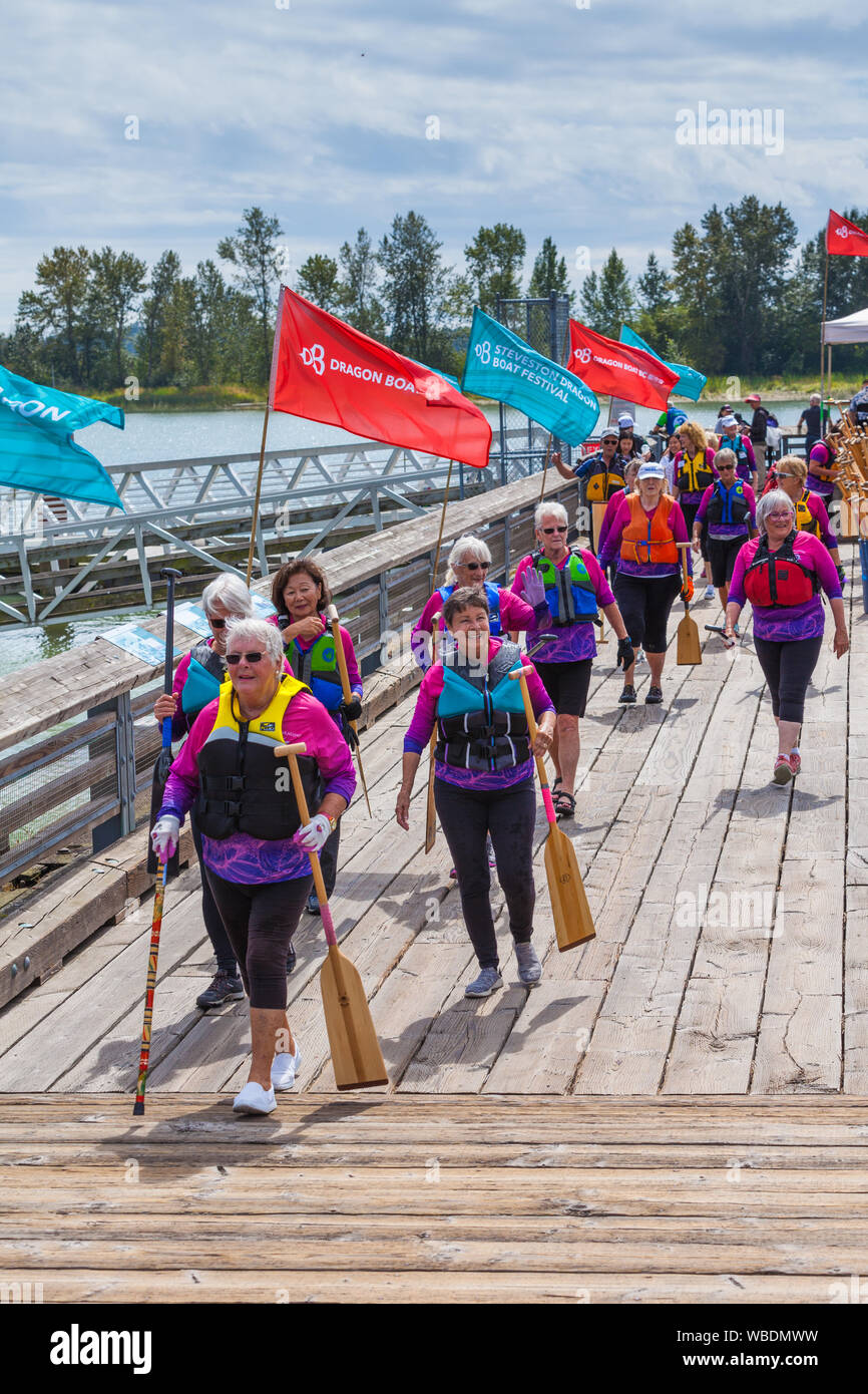Senior ladies team returning from their boat at the 2019 Steveston Dragon Boat festival in British Columbia Canada Stock Photo