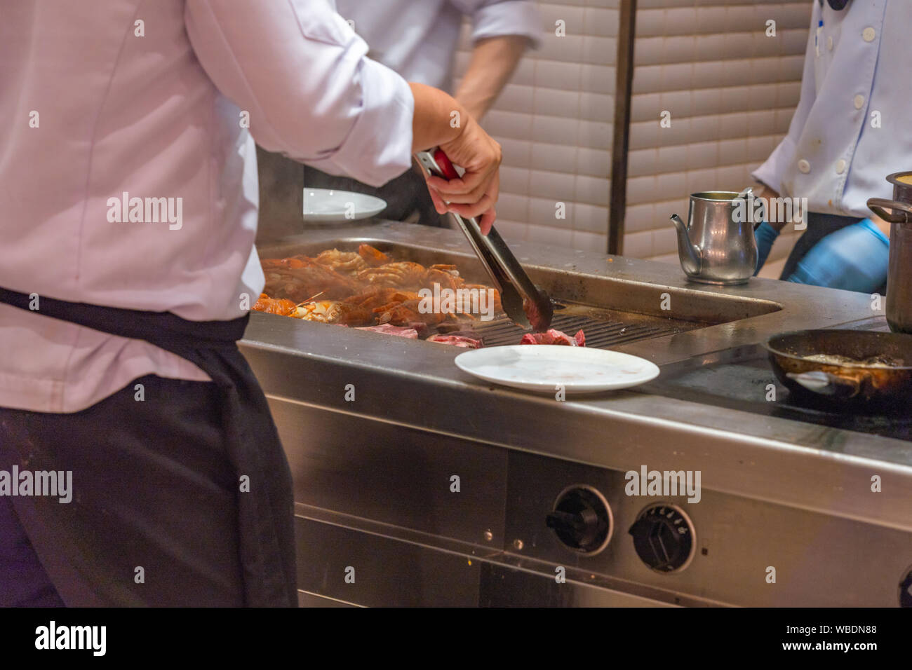 The Cooking Chef Preparing Grilled Lobsters On Electric Stove