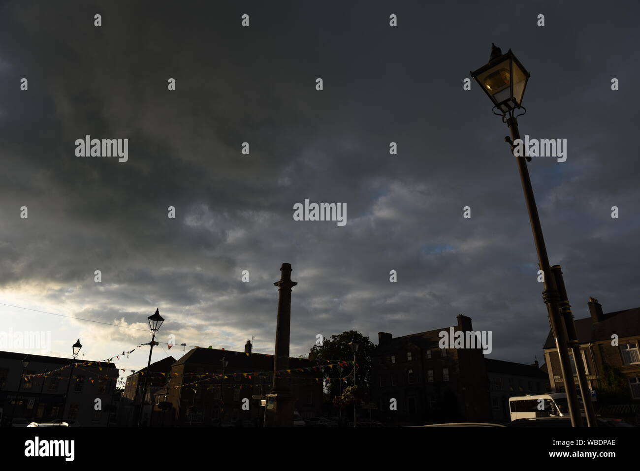sunset with a grey and black sky Stock Photo - Alamy