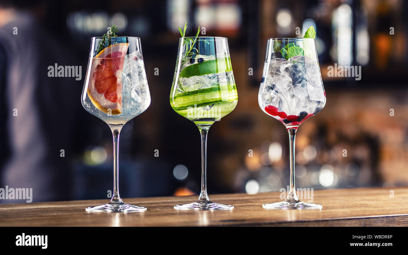 Gin tonic cocktails in wine glasses on bar counter in pup or restaurant Stock Photo
