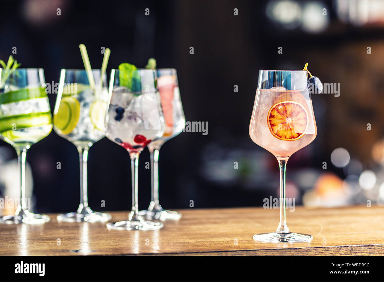Gin tonic cocktails in wine glasses on bar counter in pup or restaurant Stock Photo