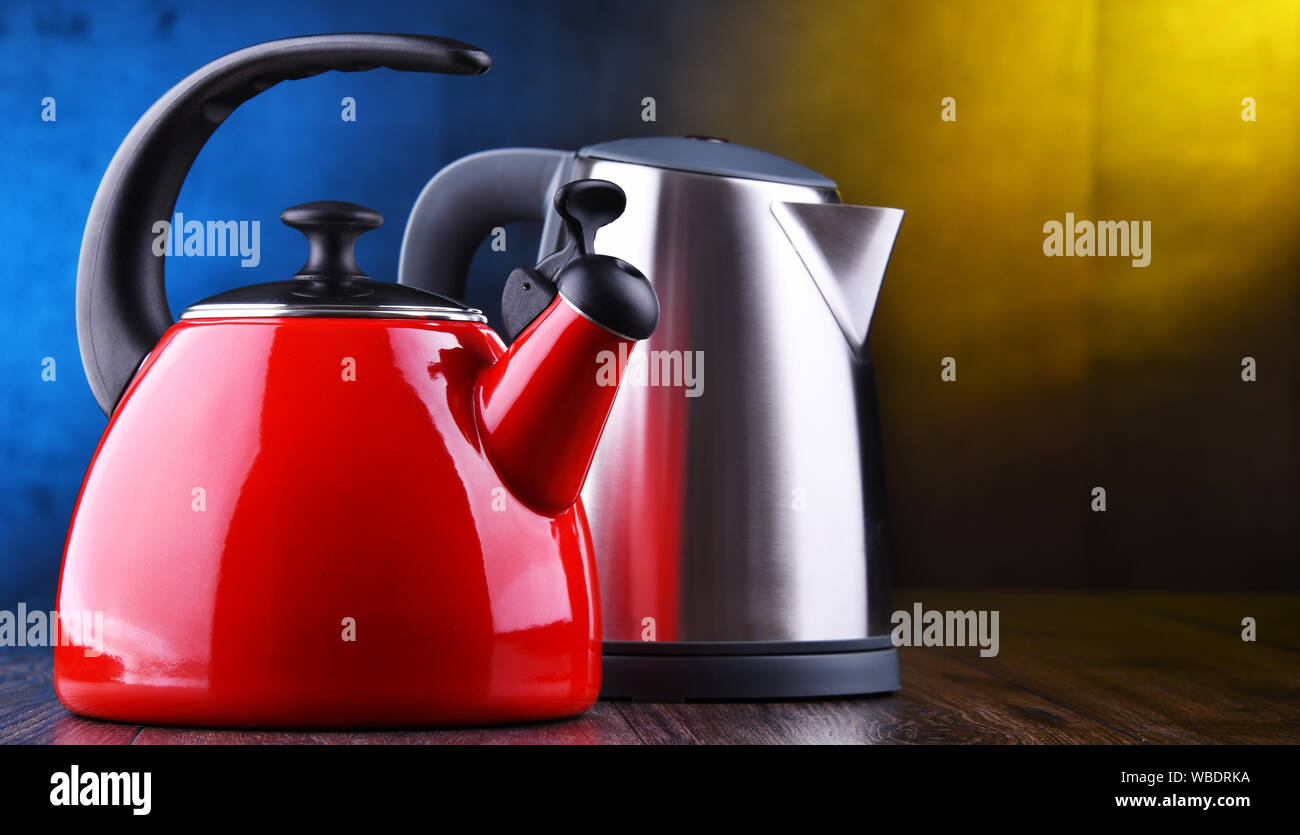 Traditional stovetop kettle with whistle and modern electric cordless kettle Stock Photo Alamy