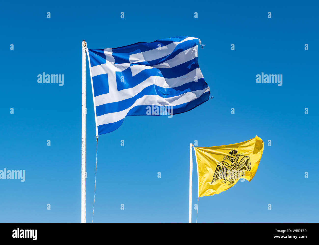 National Flag of Greece and Byzantine Flag against blue sky background. Stock Photo