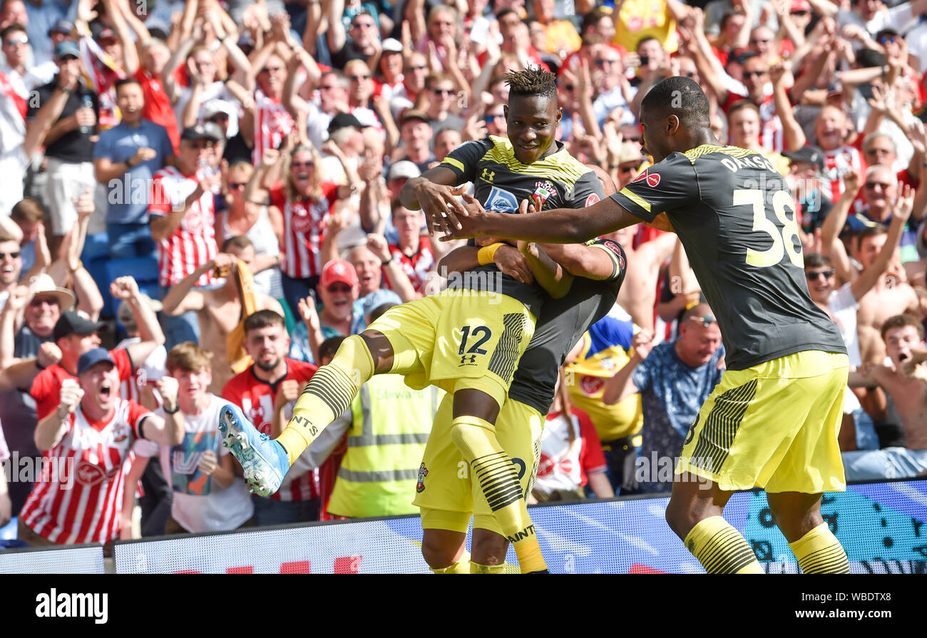 Moussa Djenepo of Southampton (left) is mobbed after scoring their first goal during the Premier League match between Brighton and Hove Albion and Southampton at the American Express Community Stadium , Brighton , 24 August 2019 Editorial use only. No merchandising. For Football images FA and Premier League restrictions apply inc. no internet/mobile usage without FAPL license - for details contact Football Dataco Stock Photo