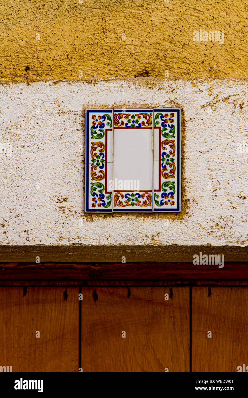Traditional decorative street number plate from facade of old house in Nimes, France Stock Photo