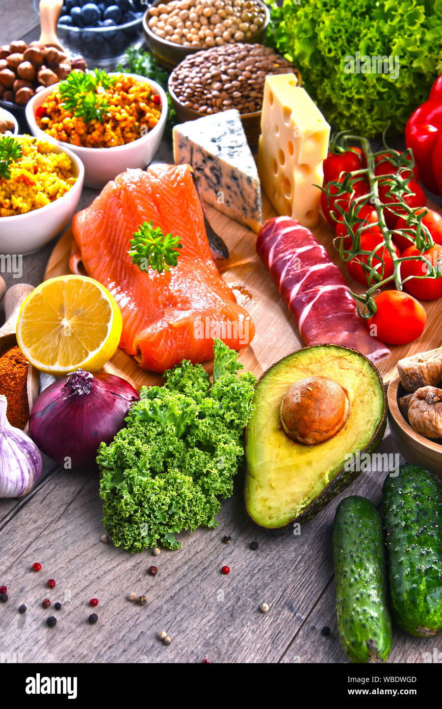 Composition with assorted food products on kitchen table Stock Photo ...